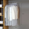 A transparent zippered garment bag with hangers displaying white and beige clothing items for storage.