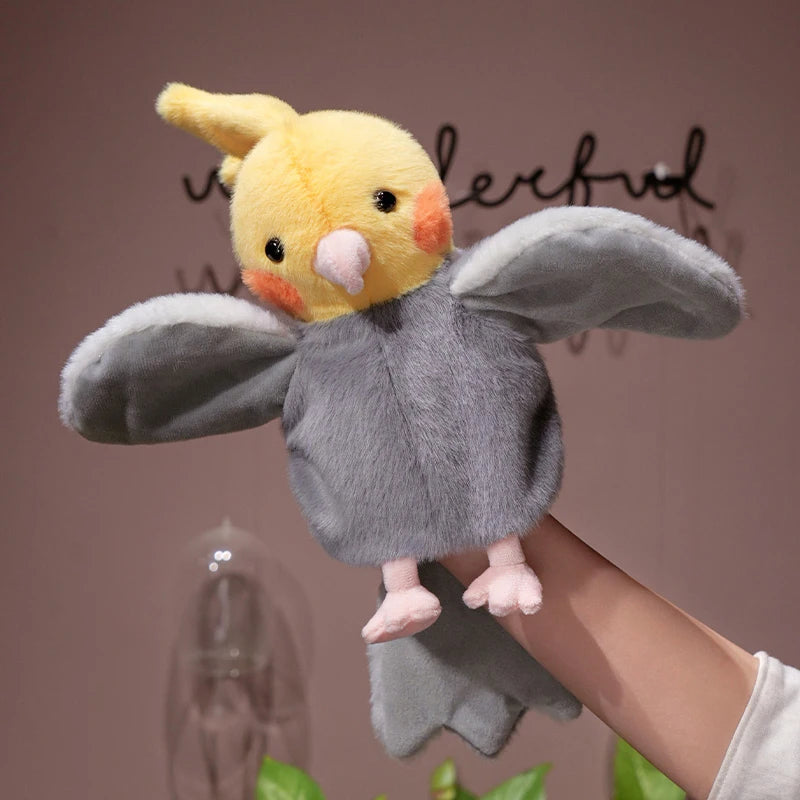 A fluffy yellow and gray plush parrot hand puppet toy being held by a person.