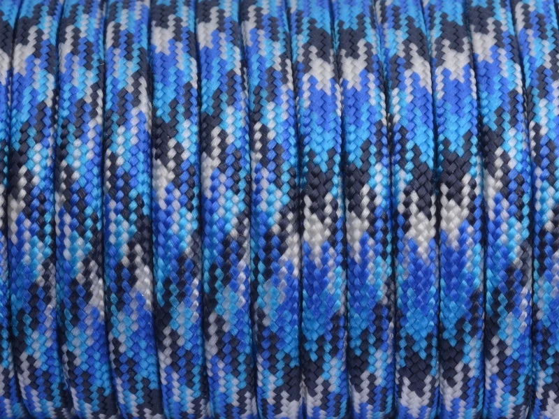 Blue and gray paracord rope wound tightly on a spool.