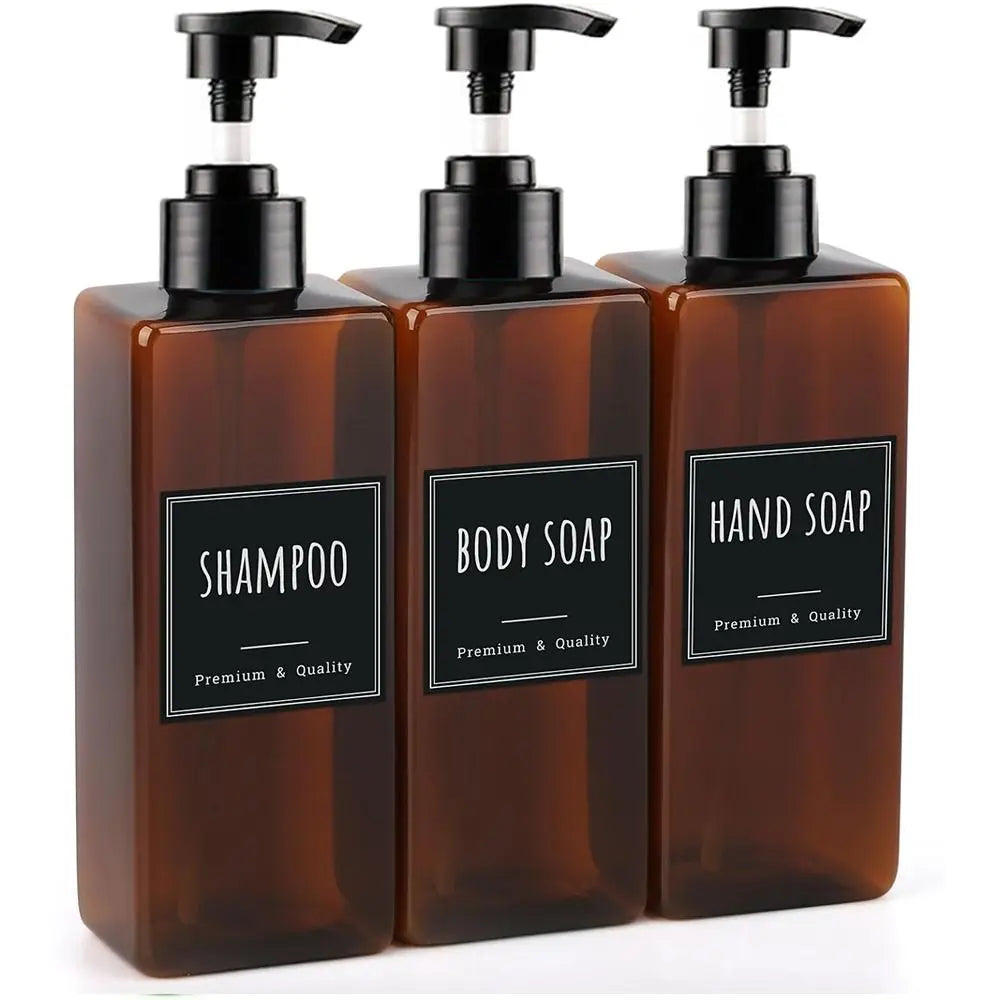 A three-pack of amber glass refillable soap dispenser bottles labeled Shampoo, Body Soap, and Hand Soap.