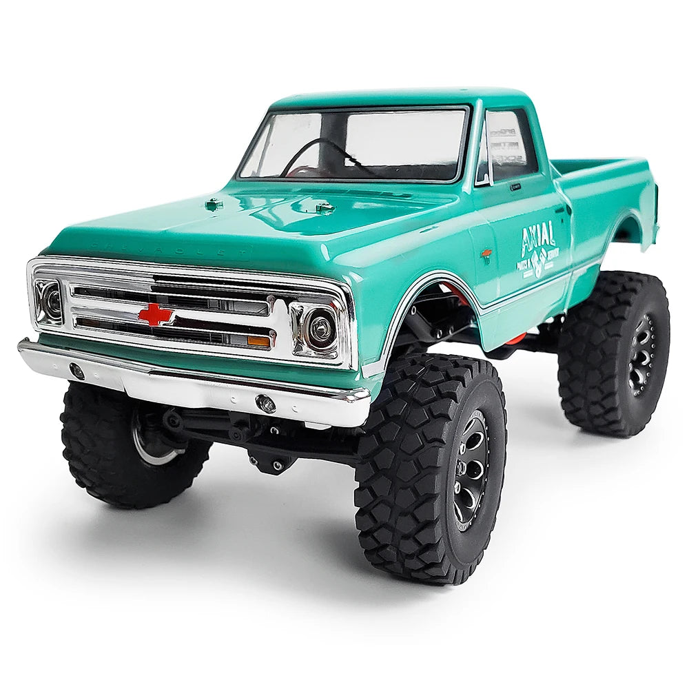 A teal Ford pickup truck model with large off-road tires and a chrome grille.