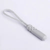 A replacement zipper pull with a silver-colored plastic end and a white nylon cord.