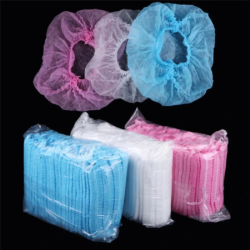 A collection of colorful disposable hair net caps in pink, purple, and blue are displayed on a black background.