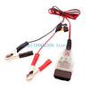 Red and black OBD2 battery memory saver device with a digital display and wiring.