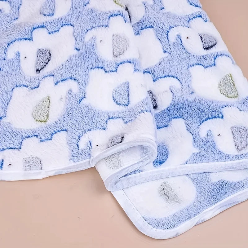 A light blue and white flannel blanket patterned with cartoon elephants for pets.