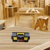 A black and yellow plastic toolbox with secure latches resting on a light wood table.