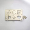 A brass Montessori busy board with five wooden shapes, including a triangle, circle, square, star, and heart.