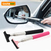 A silver retractable car mirror and window cleaning wiper is shown being used on a vehicle's side mirror.