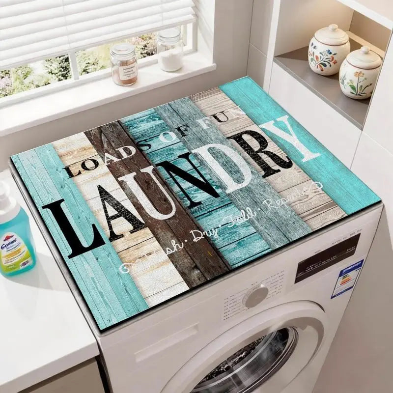 A laundry mat featuring wood grain textures and blue accents placed on a white washing machine top.