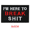 Black embroidered iron-on letter patch with white and red text that reads I'm here to break shit
