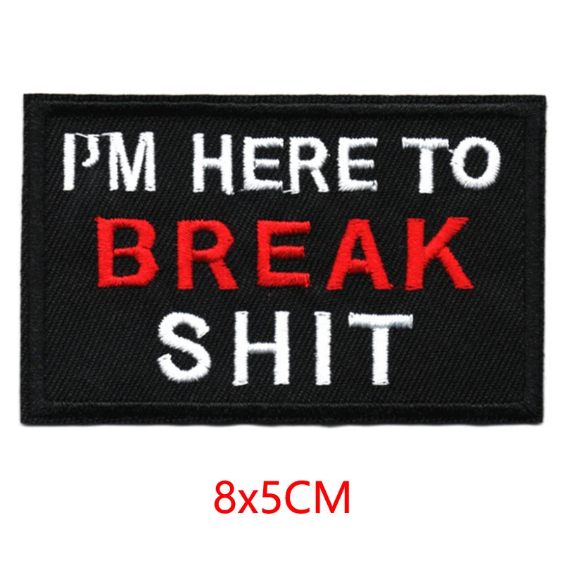 Black embroidered iron-on letter patch with white and red text that reads I'm here to break shit