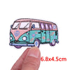 A pink and teal cartoon bus embroidery patch with purple windows and floral details.