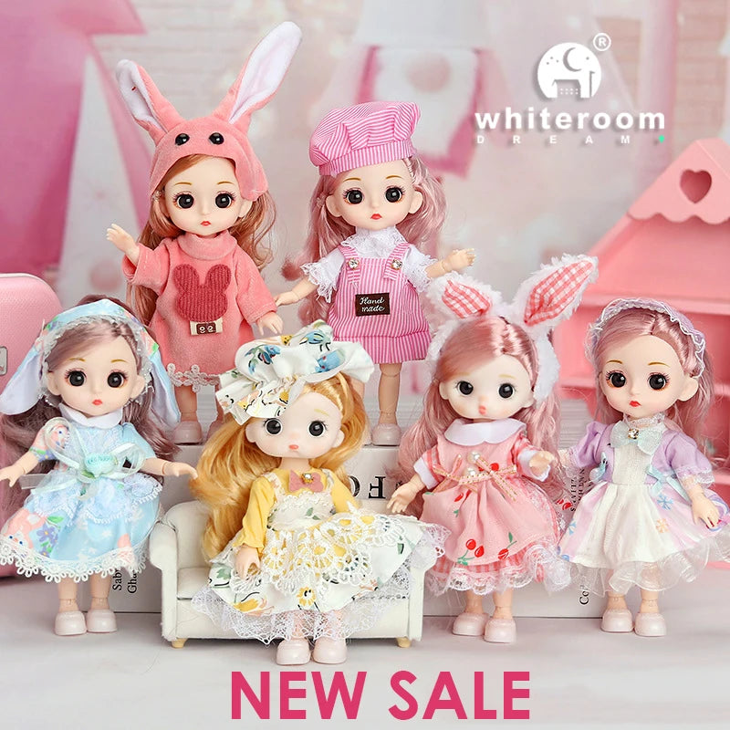A collection of several poseable fashion dolls with pink and white outfits displayed in a studio setting.