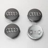 Four views of Audi center hub caps with decorative wheel covers, showing the logo and mounting mechanism.