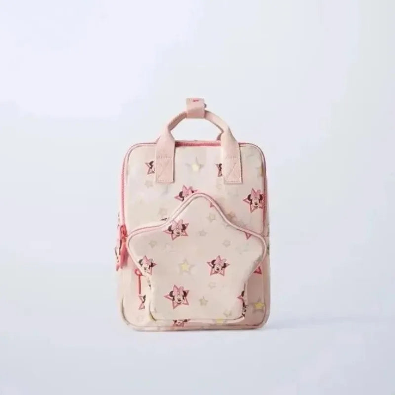 A light pink backpack with a cute cow print pattern and pink accents.
