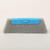A blue multi-purpose crevice cleaning brush with a flexible head rests on a gray foam block.