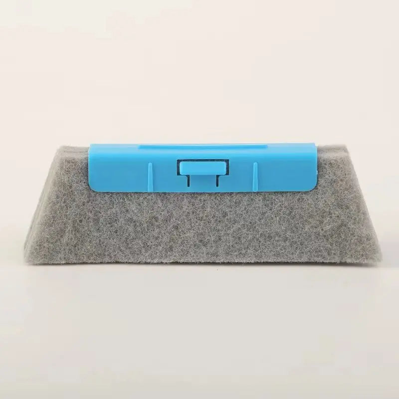 A blue multi-purpose crevice cleaning brush with a flexible head rests on a gray foam block.