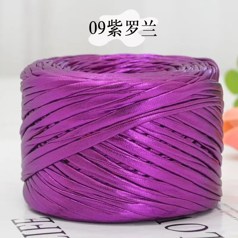 Purple metallic flat ribbon yarn coiled for crochet and knitting