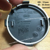 A close-up view of a black wheel center hub cap with Nissan part numbers and dimensions visible.