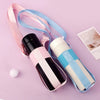 A pink and blue breathable mesh crossbody carrier for a water bottle is displayed on a purple background.