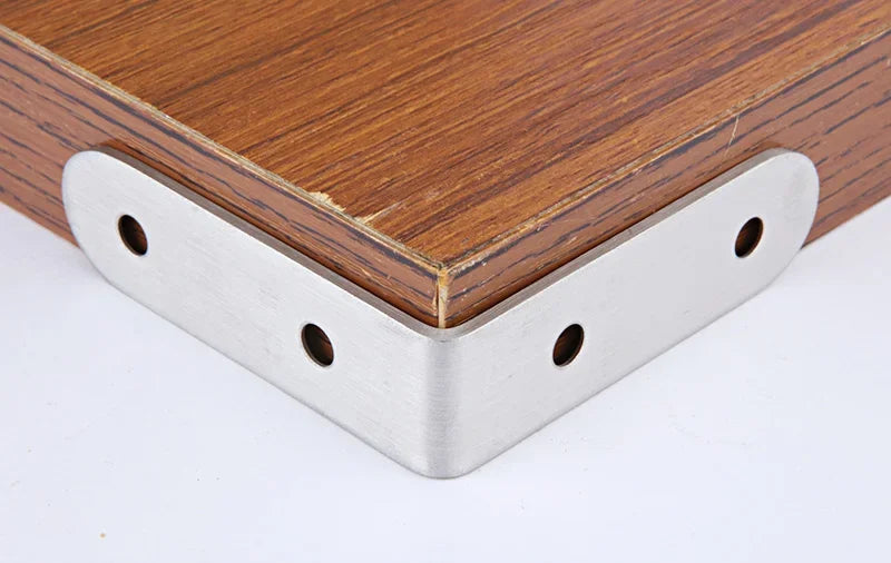 Stainless steel 90-degree angle bracket set with screws attached to a wooden piece.