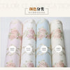 Four rolls of 3D self-adhesive floral wallpaper in pink, white, and light blue shades