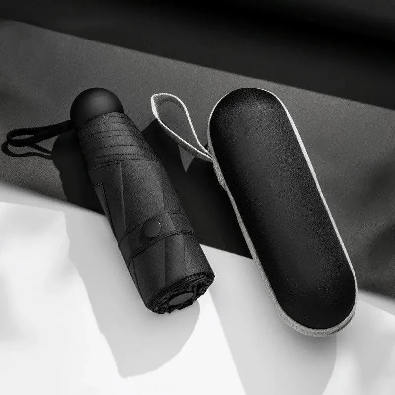 A black compact five-fold umbrella with a protective sleeve is shown against a light background.