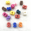 A collection of ten mixed alphabet letter beads in various colors and shapes for DIY jewelry making