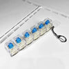 A string of clear LED mechanical keychain fidget toys with blue keycaps attached to a metal chain.