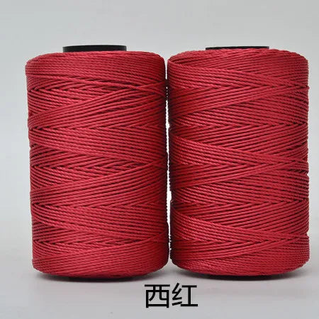 Two spools of red 3-ply polyester knitting yarn for crochet and hand crafts