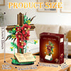 A Jesus cross flower building set featuring a wooden cross adorned with red and yellow flowers and an open book.