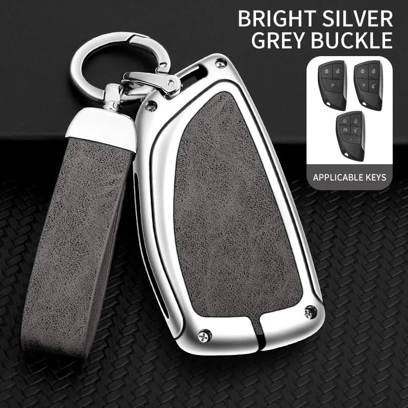 A bright silver grey buckle car key case with a leather strap and multiple keys displayed on a black background.