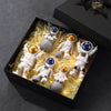 A black box contains several handcrafted astronaut figurine resin spaceman desk decor figures surrounded by yellow filler.