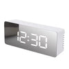 A white digital weather station clock displaying the time 12:30.