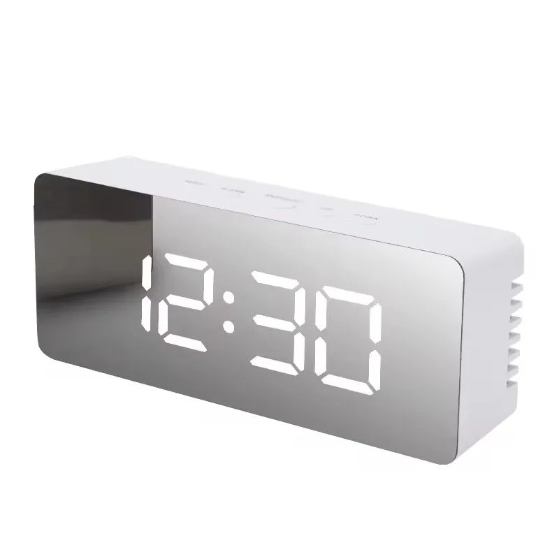 A white digital weather station clock displaying the time 12:30.