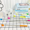 A set of five silver retractable teacher pointers with colored tips are displayed on a white checkered cloth.