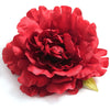 A vibrant red silk peony flower head with ruffled petals.