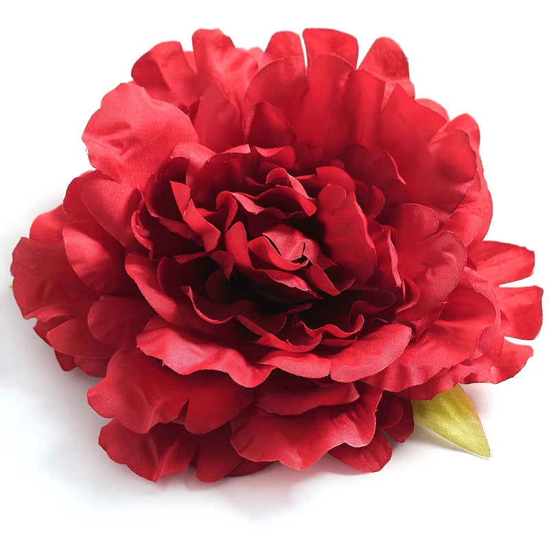 A vibrant red silk peony flower head with ruffled petals.
