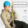 A person wearing a blue helmet is using a light weight auxiliary rope for climbing or descent safety.