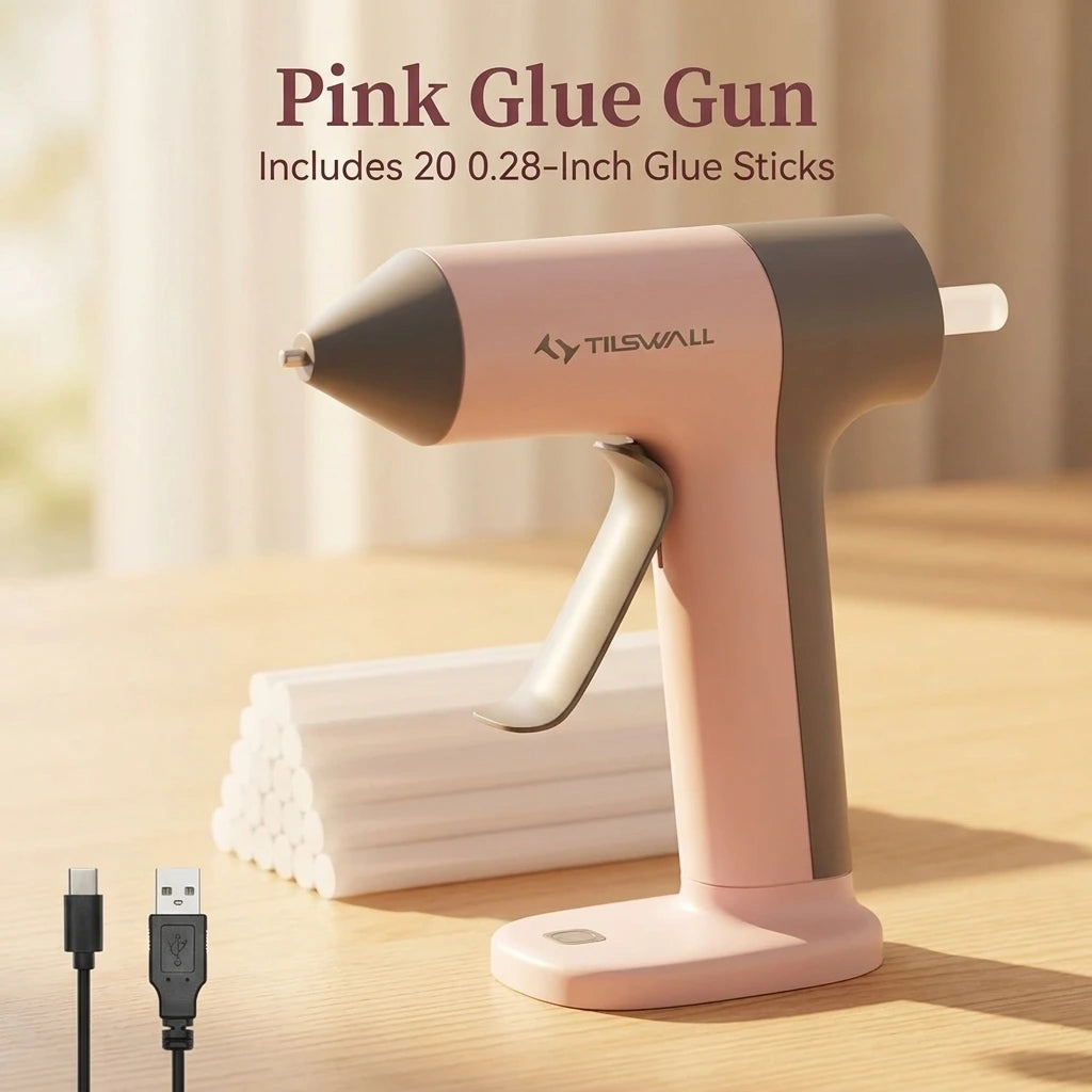 A pink glue gun is shown on a wooden surface with glue sticks and a USB cable nearby.