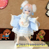 A detailed photograph of a sweet maid dress outfit for a 1/8 or 1/12 BJD doll, featuring light blue and white fabric with lac