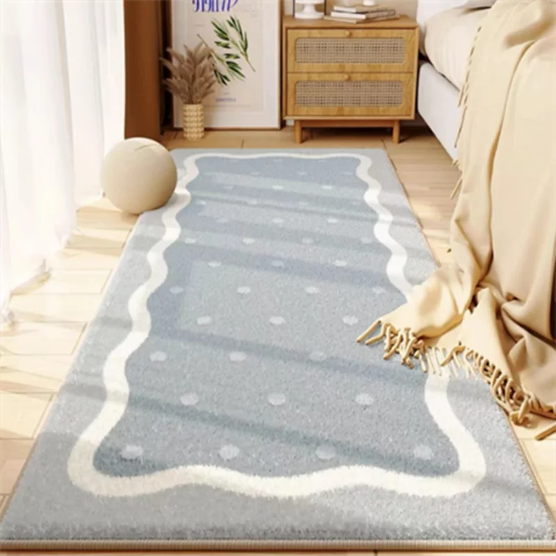 A light blue and white patterned area rug placed on a wooden floor next to a sofa and a wooden cabinet.