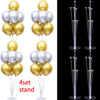 A set of four clear plastic balloon column stands for party decor, featuring gold and silver balloons.