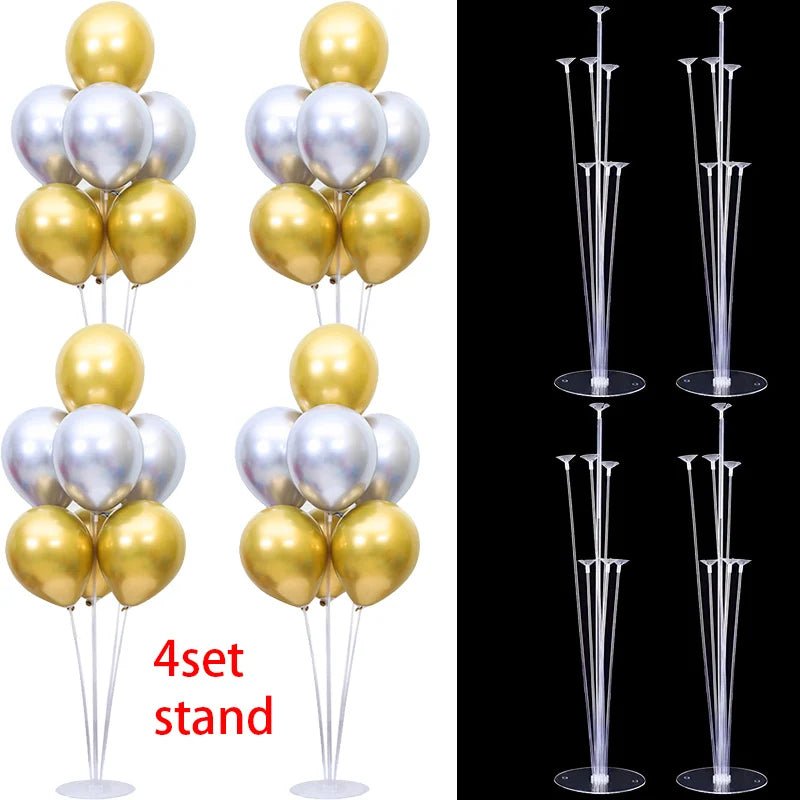 A set of four clear plastic balloon column stands for party decor, featuring gold and silver balloons.