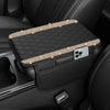 A black diamond quilted car armrest cover with storage featuring gold stitching and a smartphone slot.
