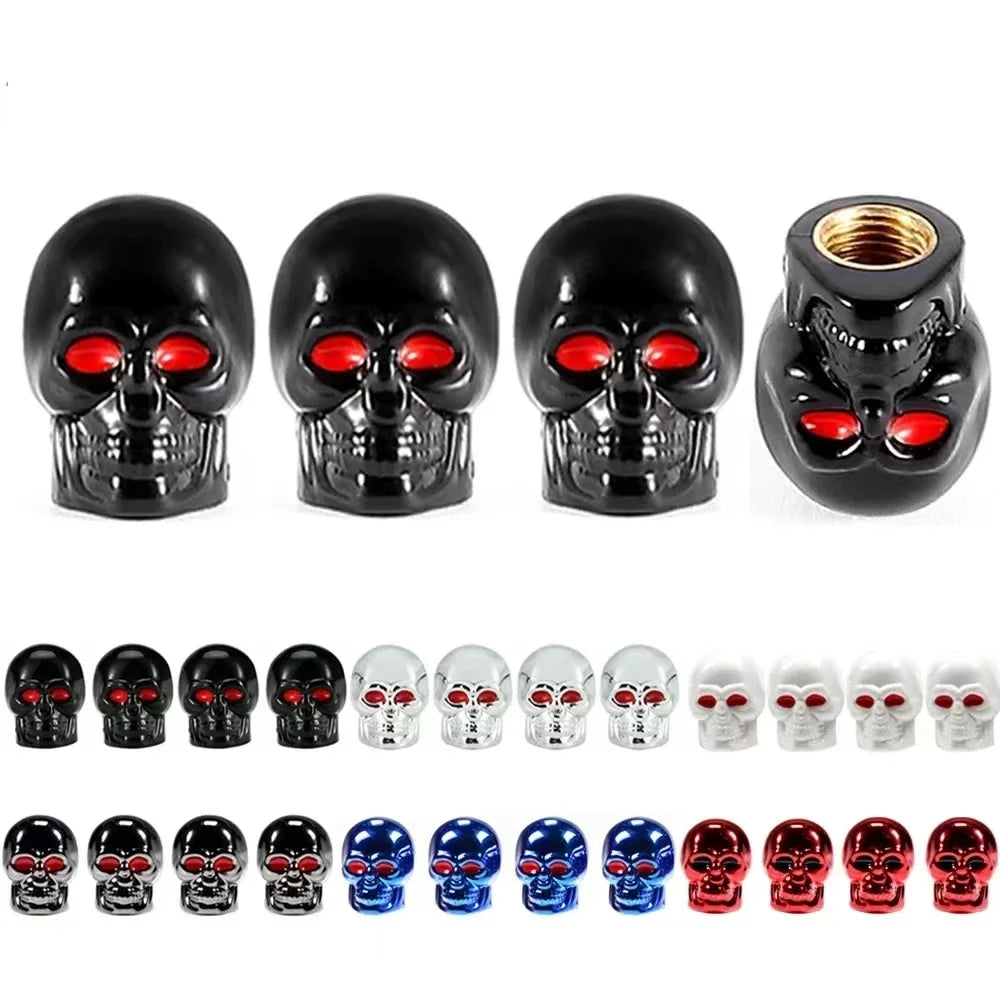 A set of four black skull design tire valve stem caps with red accents.