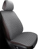 A close-up view of a dark gray quilted car seat cover set with brown accents.