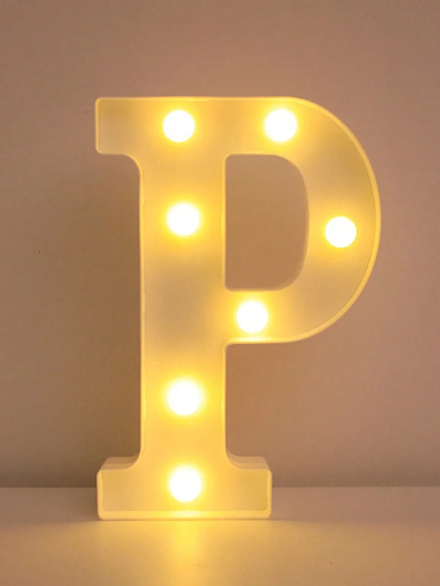 A glowing yellow LED letter P night light with illuminated dots, used for home and party decor.