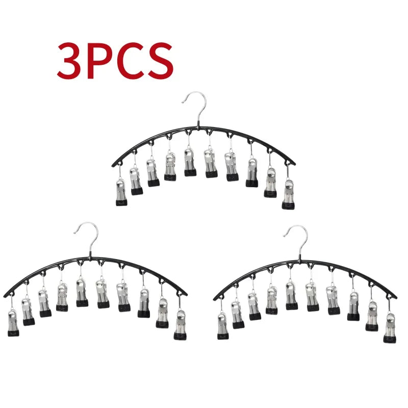 Three metal pant hangers with hooks and clips displayed against a white background.