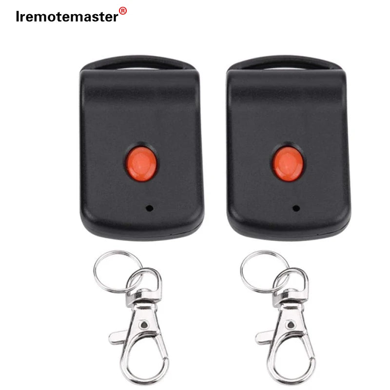 Black garage door remote control with a dip switch programming feature and attached metal key ring.